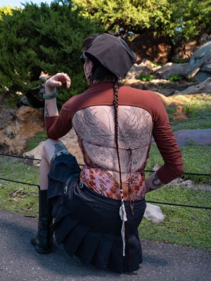 Diaz showing off their butterfly back tattoo.