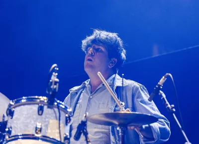 Drummer for Kevin Morby playing on stage, sticks raised during their opening set for Lord Huron.
