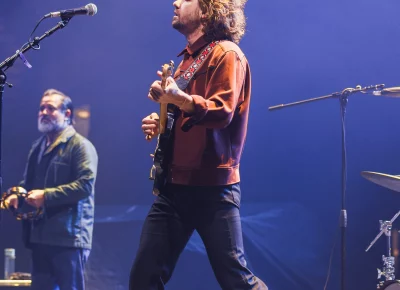 Kevin Morby (center) and saxophone player Cochemea Gastelum (left) on stage during an opening set for the Lord Huron show at the UCCU center in Orem, UT.