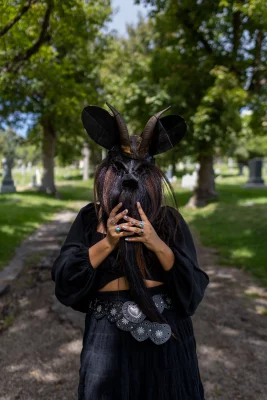 Litzi Estrada poses confidently in a graveyard.