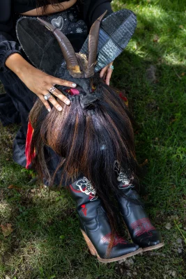 Litzi Estrada holding a horned mascara accessory for Halloween