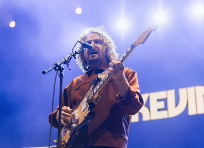 Kevin Morby playing guitar and singing at UCCU Center, opening for Lord Huron.