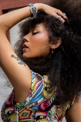 Adaline Rae posing in their colorful dress. 