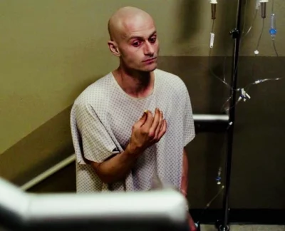 A man in a hospital gown.