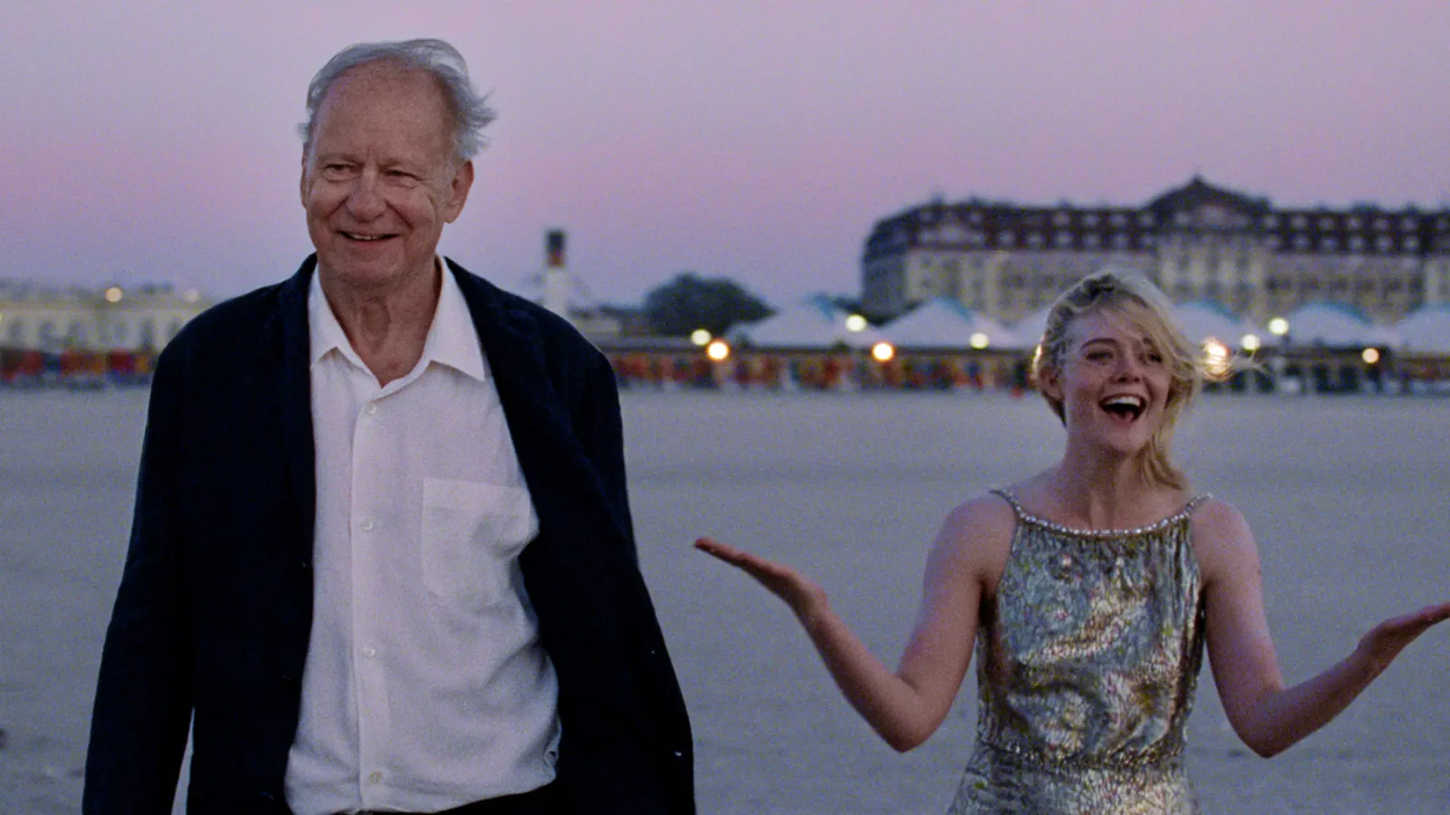 Stellan Skarsgård and Elle Fanning interact on the beach in Joachim Trier's Sentimental Value.