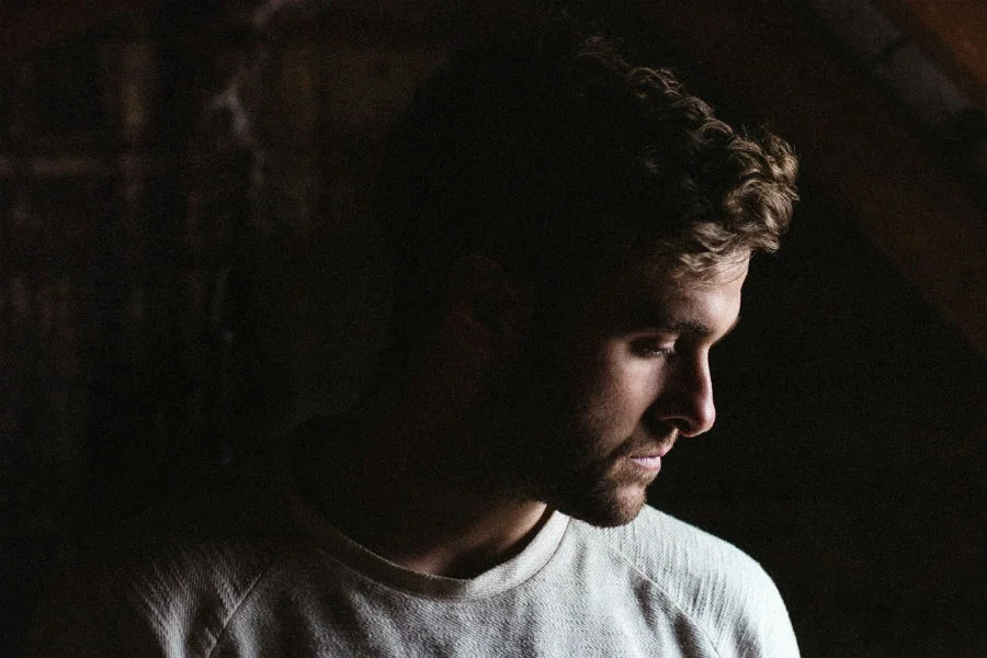 A side portrait of Irish musician Eoin French, known by his stage name, Talos.