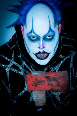PJ Stinson aka Daddy the Clown in full makeup and costume while holding what we hope is just a prop axe.