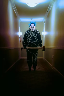 PJ Stinson aka Daddy the Clown in full makeup and costume while holding what we hope is just a prop axe.