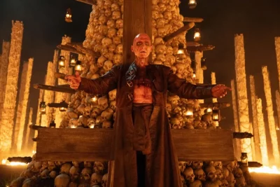 Ralph Fiennes as Dr. Kelson standing before his Bone Temple.