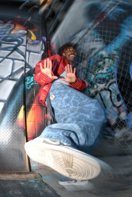 Buddy Love dances while posing