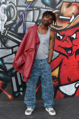 BuddyLove posing against graffiti