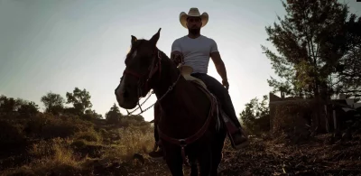 A jaripeo rides on his horse