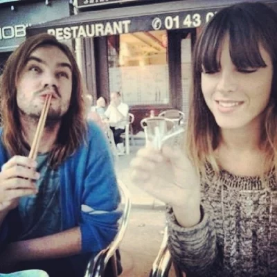 Kevin Parker of Tame Impala and Melody Prochet of Melody's Echo Chamber at an outdoor restaurant patio together around the year 2012.
