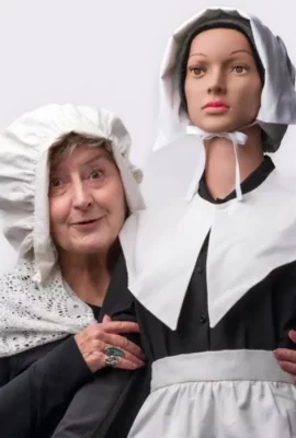 An old lady and a mannequin dressed as pilgrims. 