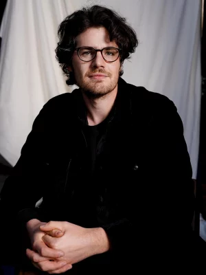 A portrait photo of director Daniel Roher.