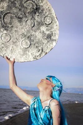 Salina Marina holding a moon on the Great Salt Lake