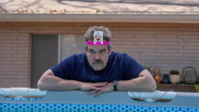A guy standing in a swimming pool. 