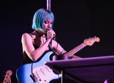 Oxis playing guitar and singing