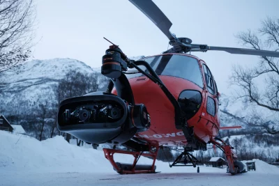A camera mounted to the front of a helicopter.