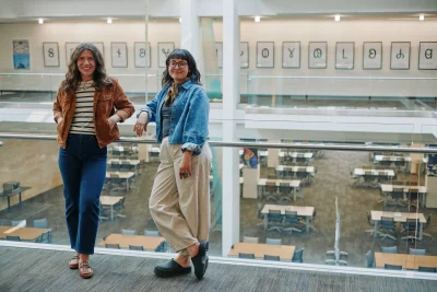 The curators of Designing Deseret standing in front of the deseret alphabet