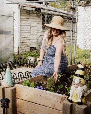 Rebecca Easter next to her garden beds.