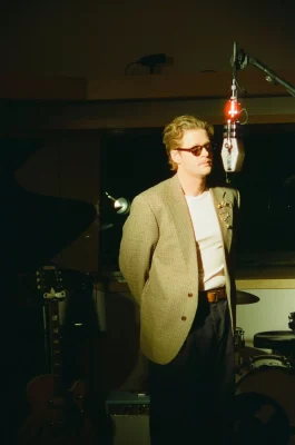 Logan James Hope standing in front of a microphone