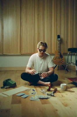 Logan James Hope sitting on the floor in his studio