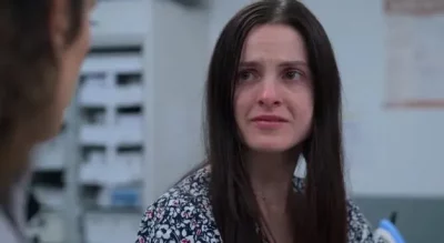 A woman looking distressed in a hospital.