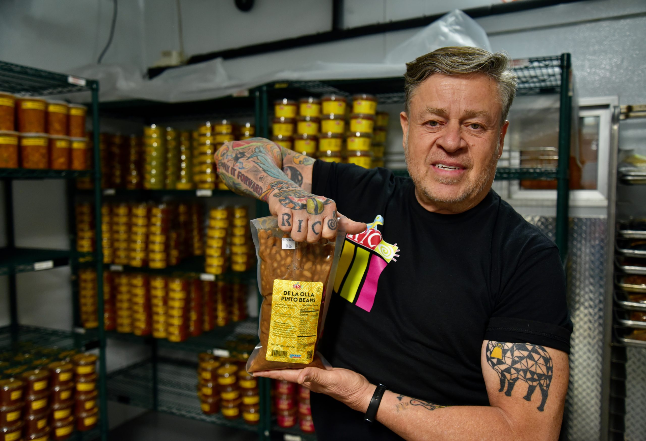 Jorge Fierro, CEO of Rico Brand, holds up a bag of de la olla pinto beans