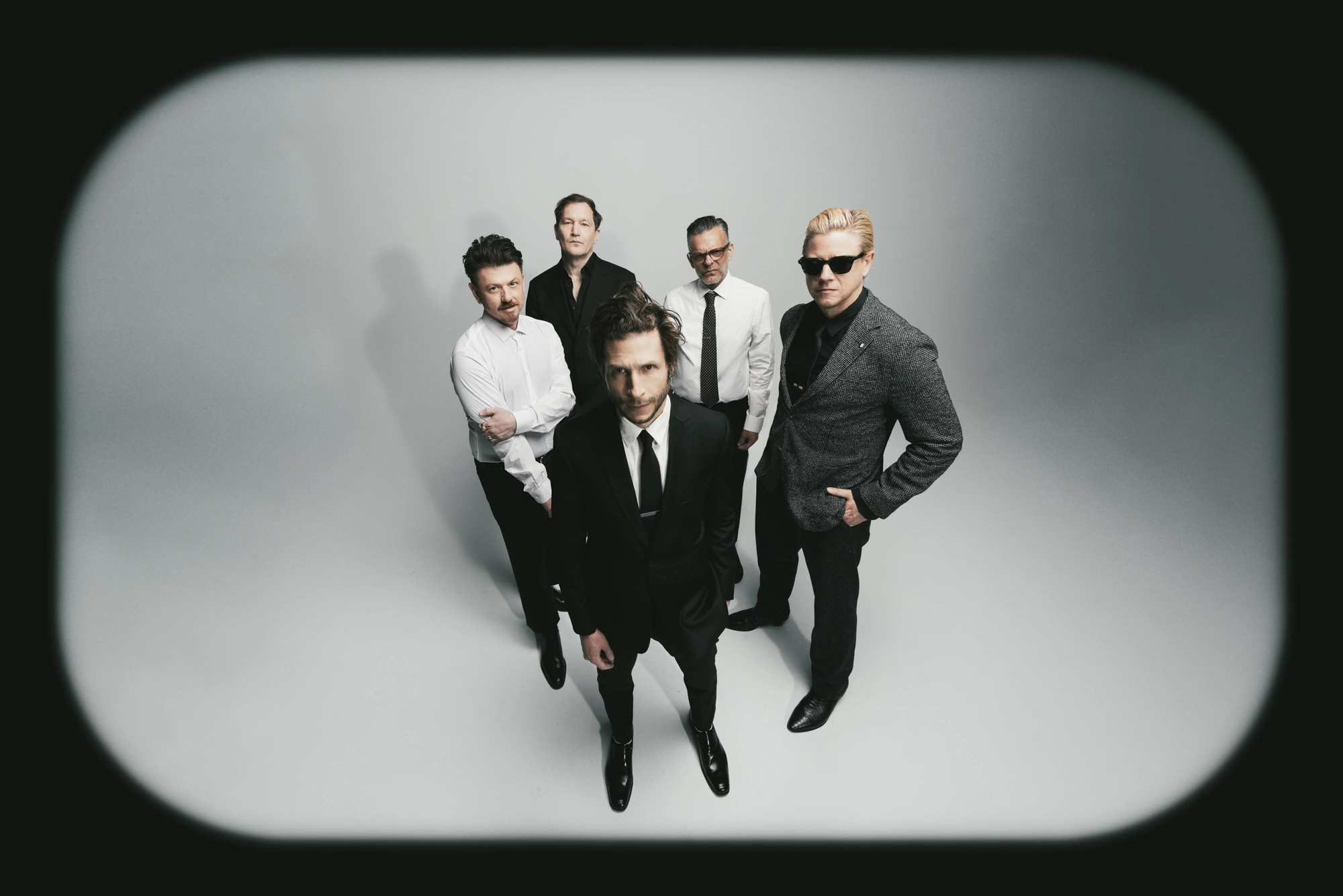A group of guys standing in a photo studio.