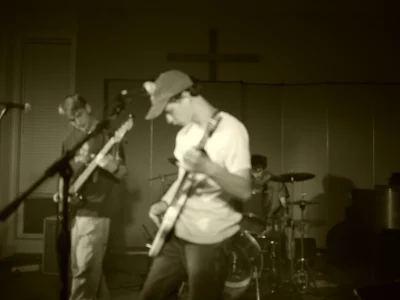 A blurry black and white image of World Record performing.
