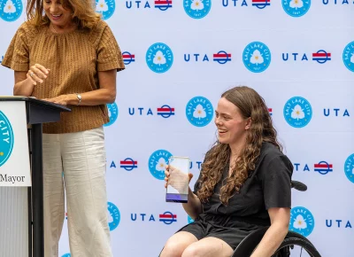 Maddie Jones holds her award as the 2026 ADA Champion during an ADA Day celebration at City Hall.
