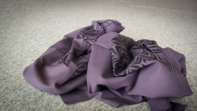 A purple LayerOne piece, decorated in tattoo-like art.