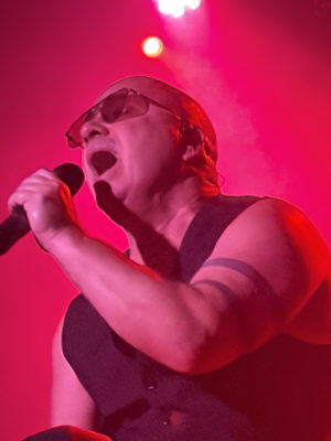Nitzer Ebb concert close-up of Bon Harris singing in red light