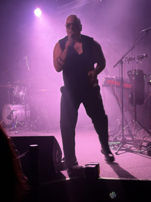 Nitzer Ebb concert in pink fog, Bon Harris singing